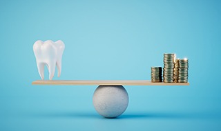 tooth and coins balanced
