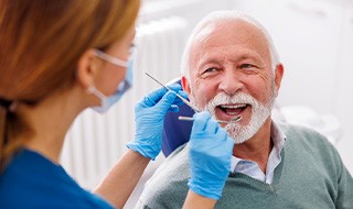 Man smiles at dentist