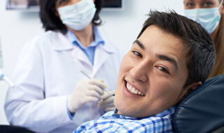 Man in dental chair smiling