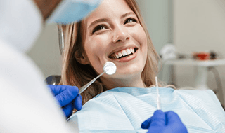 a patient in Marlton smiling while getting a dental checkup