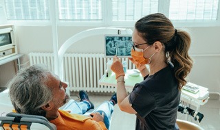 a dentist in Marlton explaining how dental crowns work 