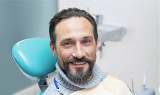 a man smiling after receiving dental crowns in Marlton 