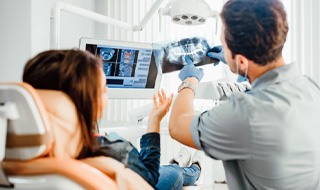 Dentist reviewing X-ray with patient at checkup