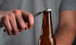 Man using bottle cap opener