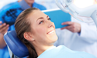 Woman smiling during dental implant process