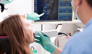 Dentist using intraoral camera to capture dental image