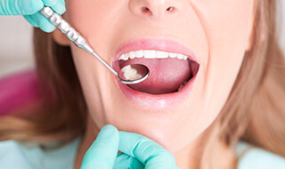 Dentist examining smile after metal free dental restorations
