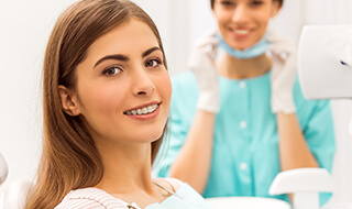Woman with orthodontics smiling