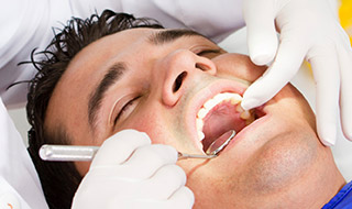 man receiving oral cancer screening