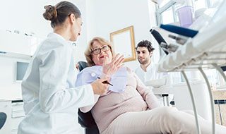 Dentist and patient discussing treatment options