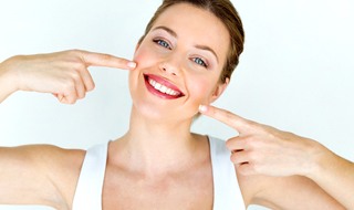 A woman pointing at her straight smile