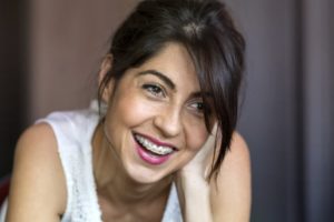 Smiling woman with braces.