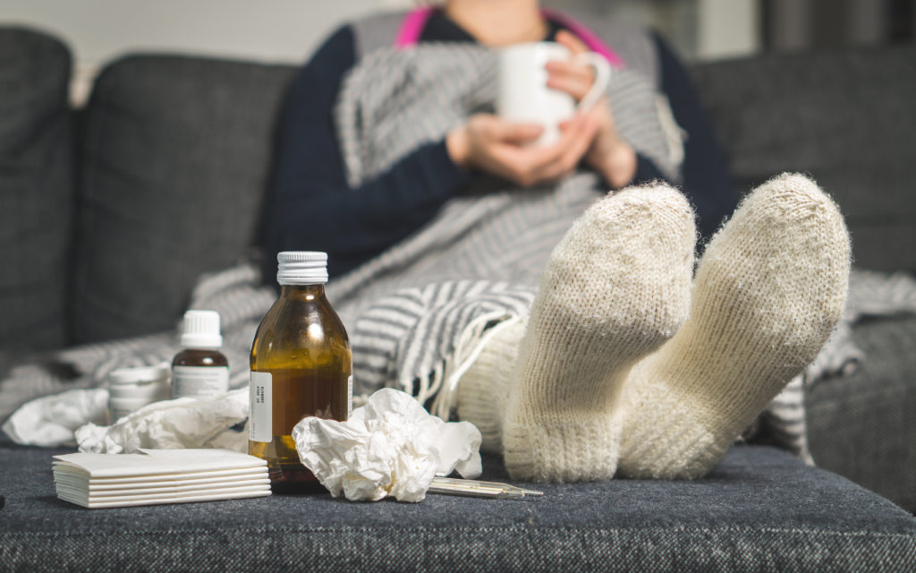 person on couch with medicine