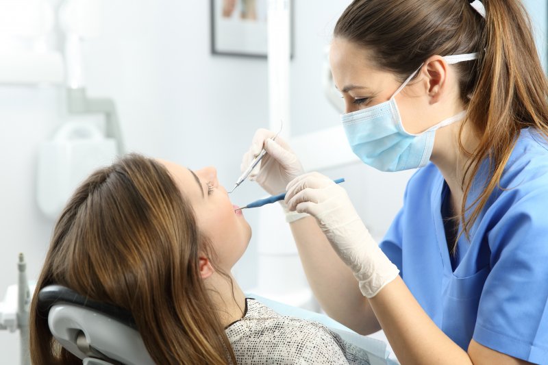 Dental hygienist examining patient's mouth