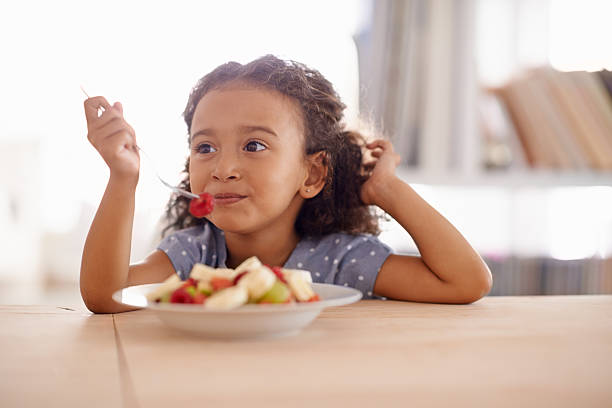 little kid eating fruit