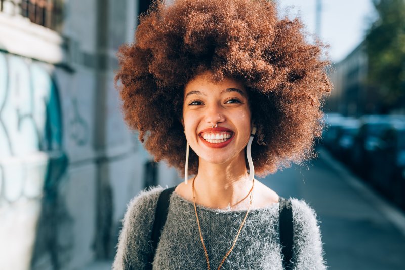 person who had cosmetic dental flaws fixed smiling