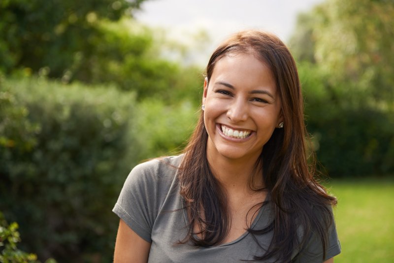 Woman smiling with her new dental implants