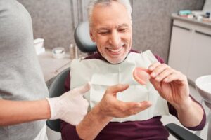 Man with dentures at his regular checkup